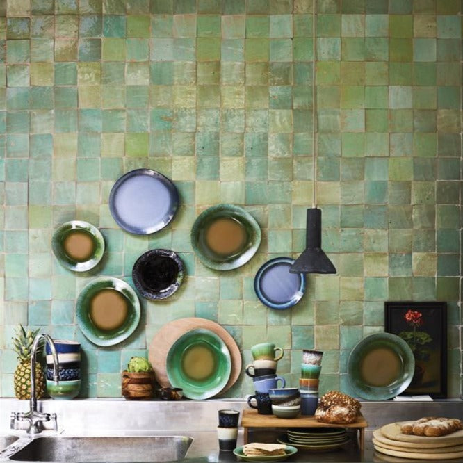 kitchen setting with ceramics and a black concrete hanging lamp