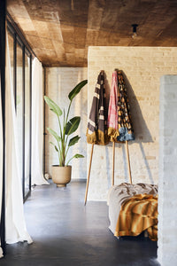 bedroom with sandstone wall with 3 parasols leaning