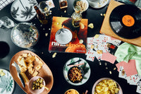 table with cards, snacks and an oval shaped serving platter
