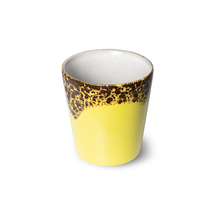 yellow and brown stoneware coffee cup