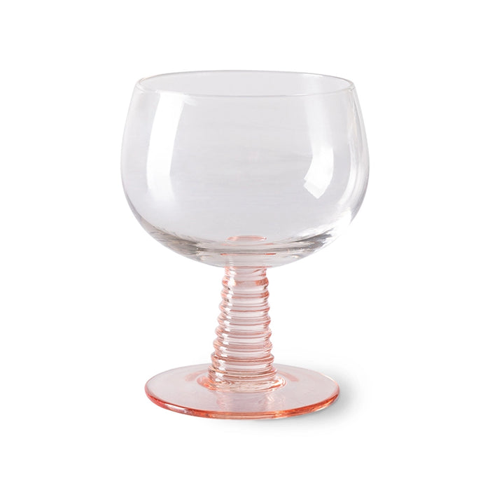 low stem wine glass with a pink foot
