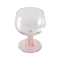 low stem wine glass with a pink foot