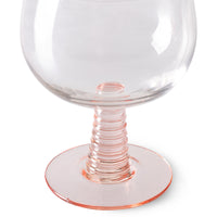 low stem wine glass with a pink foot
