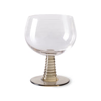 wine glass with a green colored low stem 
