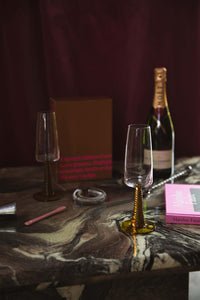 champagne glasses with ochre colored stem