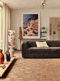 framed photo of orange parasols at Amalfi Coast in living room with brown sofa
