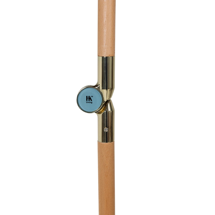 detail of pole from the retro style parasol with flower fabric and blue fringes