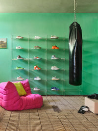  square clay color mirror block table in a room with a green wall, pink chair and boxing gear