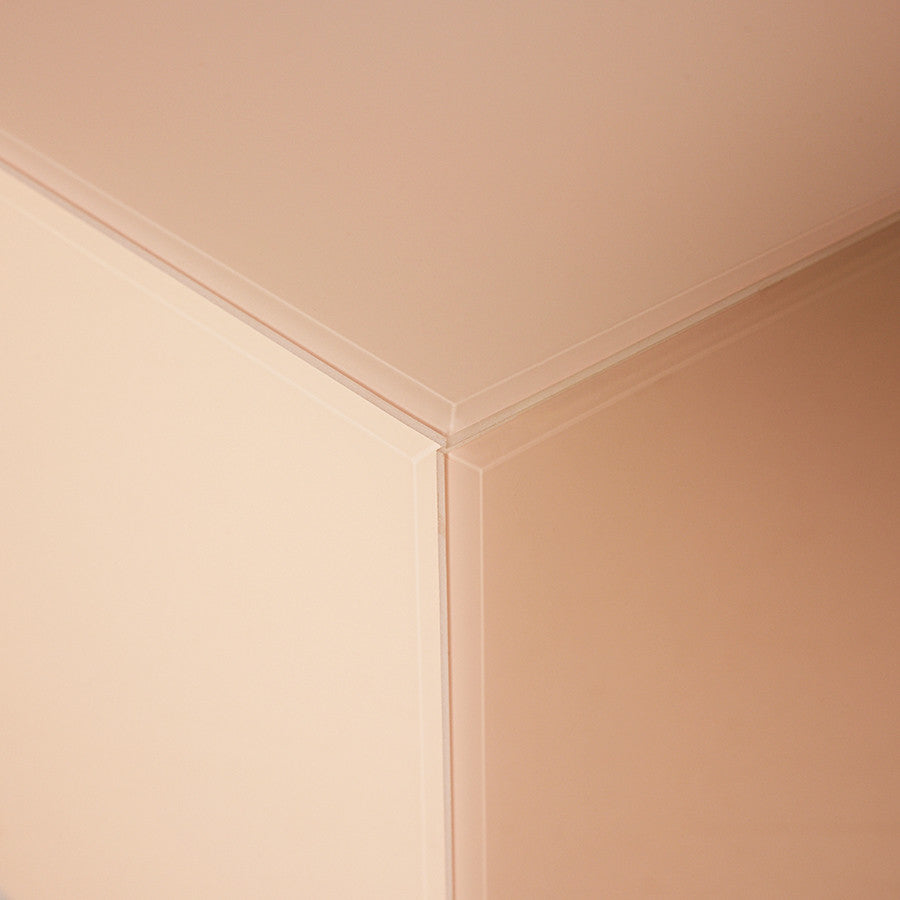 corner of  square clay color mirror block table