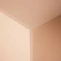 corner of  square clay color mirror block table