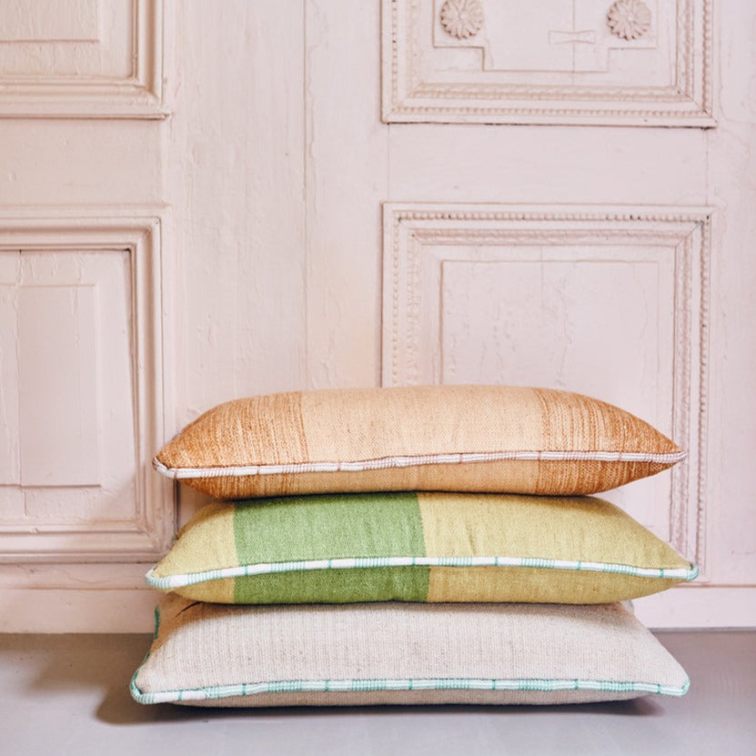 3 large hand woven woolen lumbar pillows stacked together