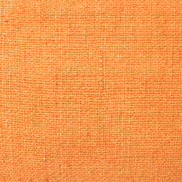 detail of the linen of orange linen lumbar pillow with brown cotton trim