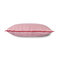 pink linen lumbar pillow with red cotton trim