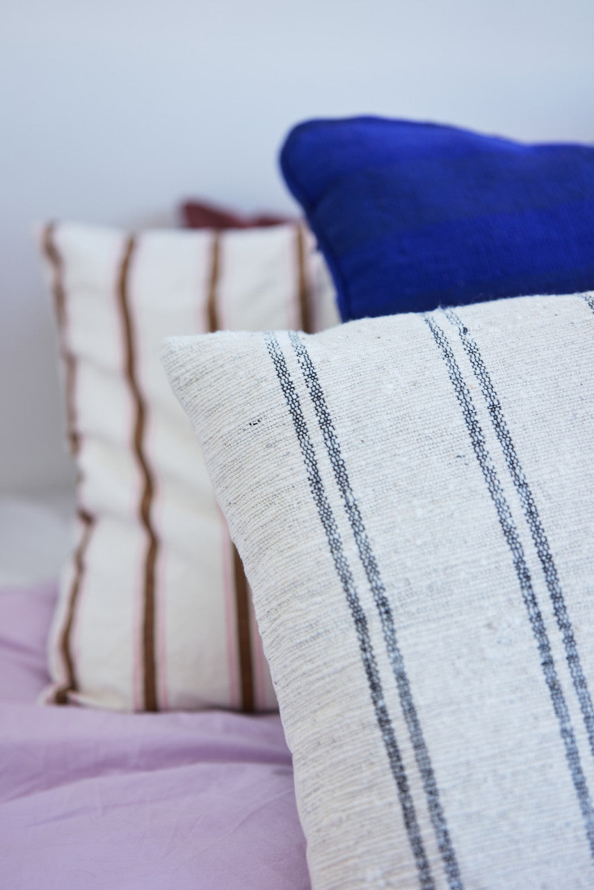 detail of natural cotton thin striped super large pillow on bed