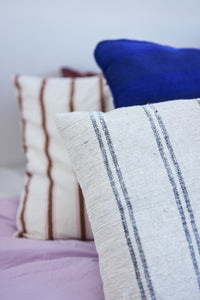 detail of natural cotton thin striped super large pillow on bed