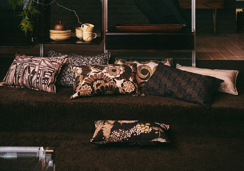 vintage inspired lumbar pillow with abstract fabric with multiple other pillows