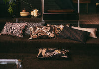 vintage inspired lumbar pillow with abstract fabric with multiple other pillows