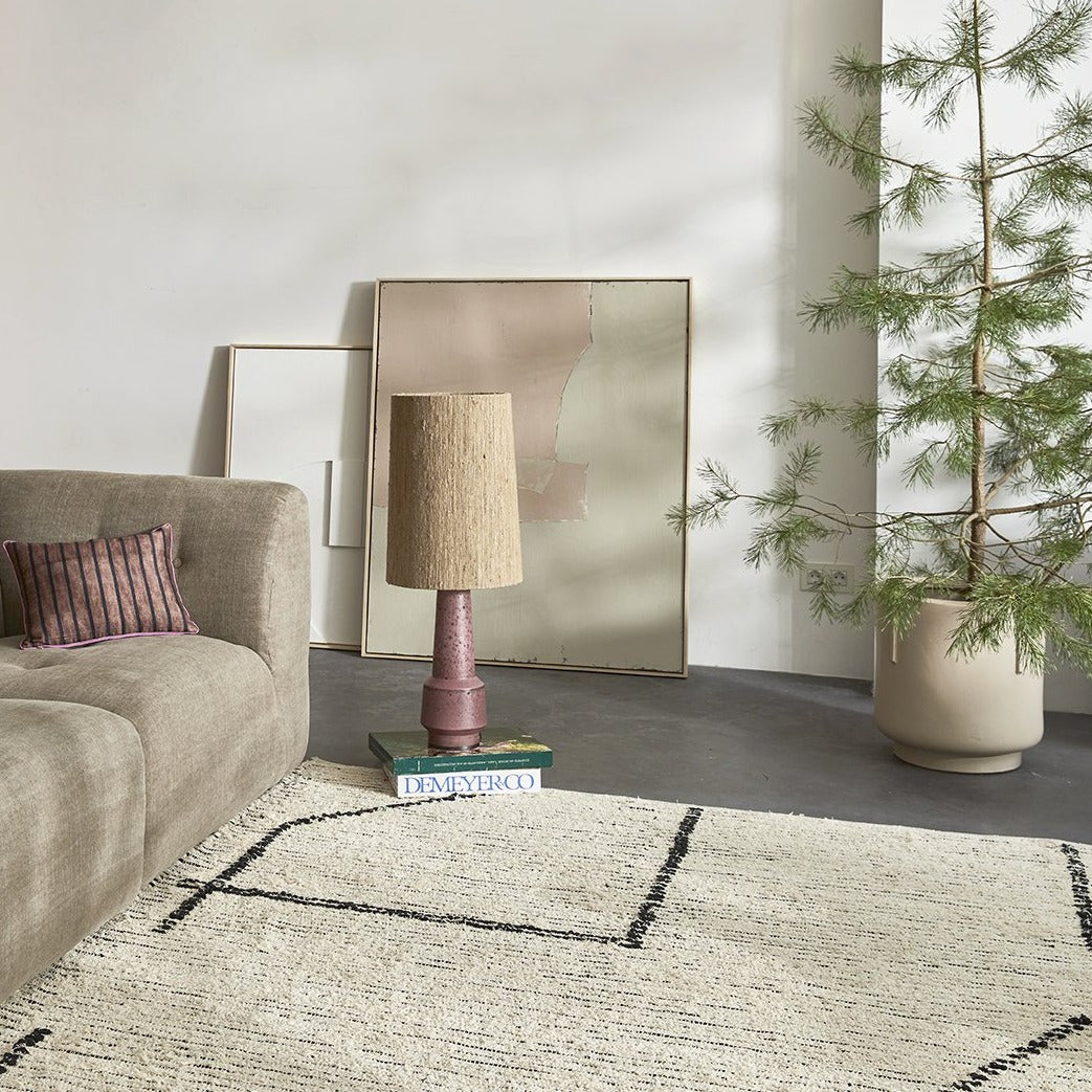 living room with grey floor and abstract painting with soft colors against the wall