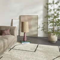 living room with grey floor and abstract painting with soft colors against the wall