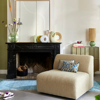 living room with a variety of ceramic flower vases on fire place mantel