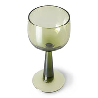 green colored wine glass on tall stem