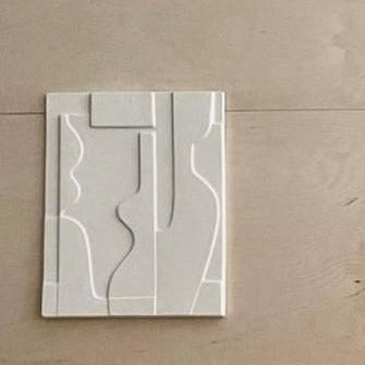 ceramic art panel on wooden wall