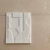 ceramic art panel on wooden wall