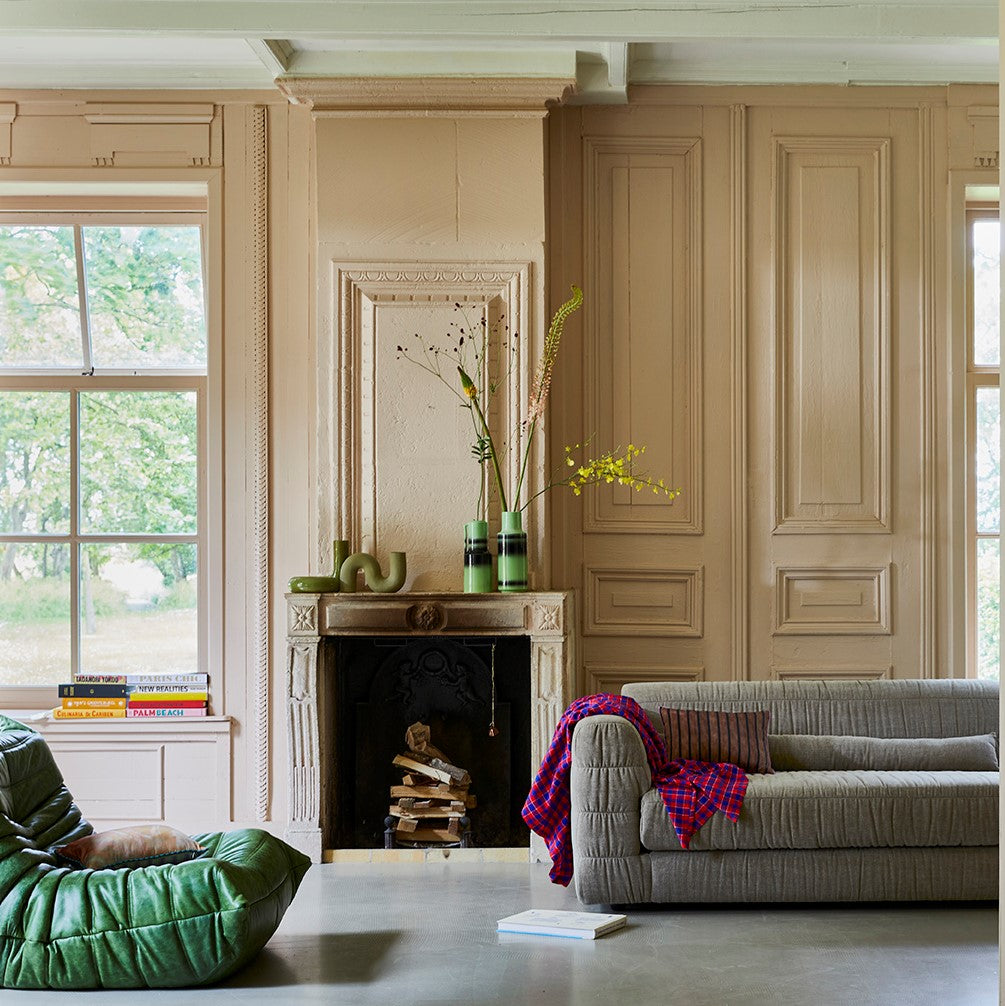 contemporary style club couch in a taupe color fabric that is a mix of linen and cotton in a room next to a fire place