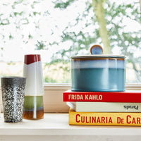 blue cookie jar made from stoneware on a stack of books