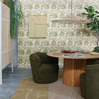 teak wooden round table with large triangle shaped wicker lamp and green chairs