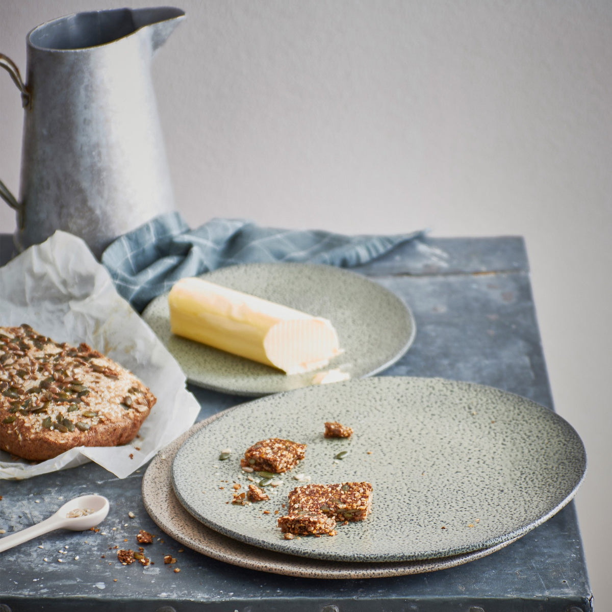 gradient dinner plate green with bread and a butter stick on a side plate