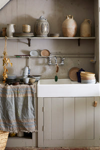 vintage style farmhouse kitchen with gradient ceramic plates and bowls