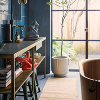 room with large window, bathtub and natural hemp runner