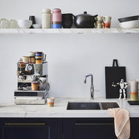 kitchen with open shelving and tow storage jars with lids 