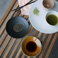 black dessert plate with herbs 