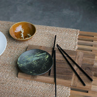 black dessert plate with matte finish and green chocolate
