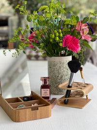 willow wood mirror box with Chanel lipstick and a brush holder and vase with flowers