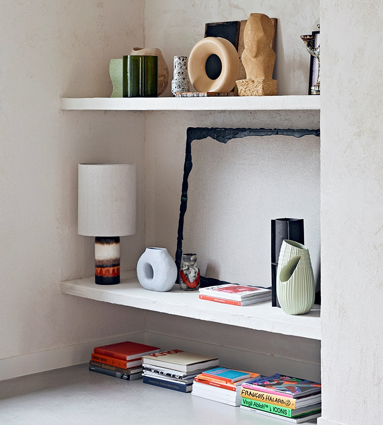 open shelving with vases in various colors as decoration 