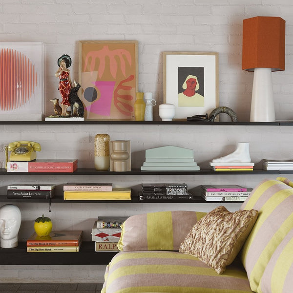 contemporary interior with table lamp with cone shaped base and hexagonal shade in orange
