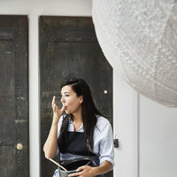 close up of white hanging ball light made of bamboo and rice paper