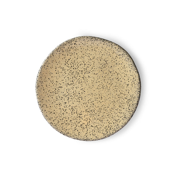 yellow and black speckled peach colored plate