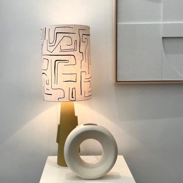 printed lampshade with a yellow base with handles