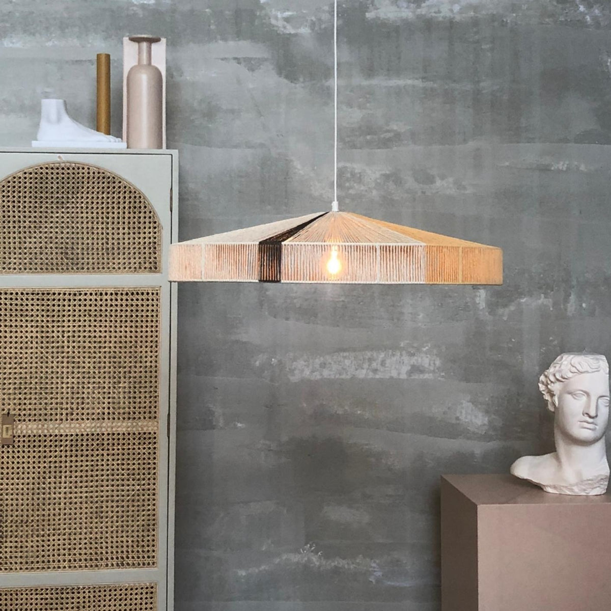 industrial looking loft with rope hanging lamp in soft colors