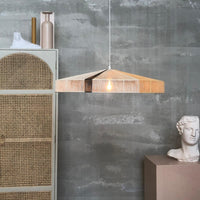 industrial looking loft with rope hanging lamp in soft colors