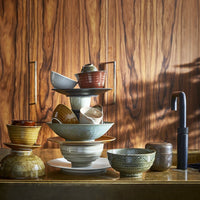 kitchen with wooden cabinets and a stack of HK living Kyoto ceramics in earth tones