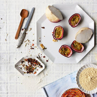 table setting with white ceramic plates and wooden spoon
