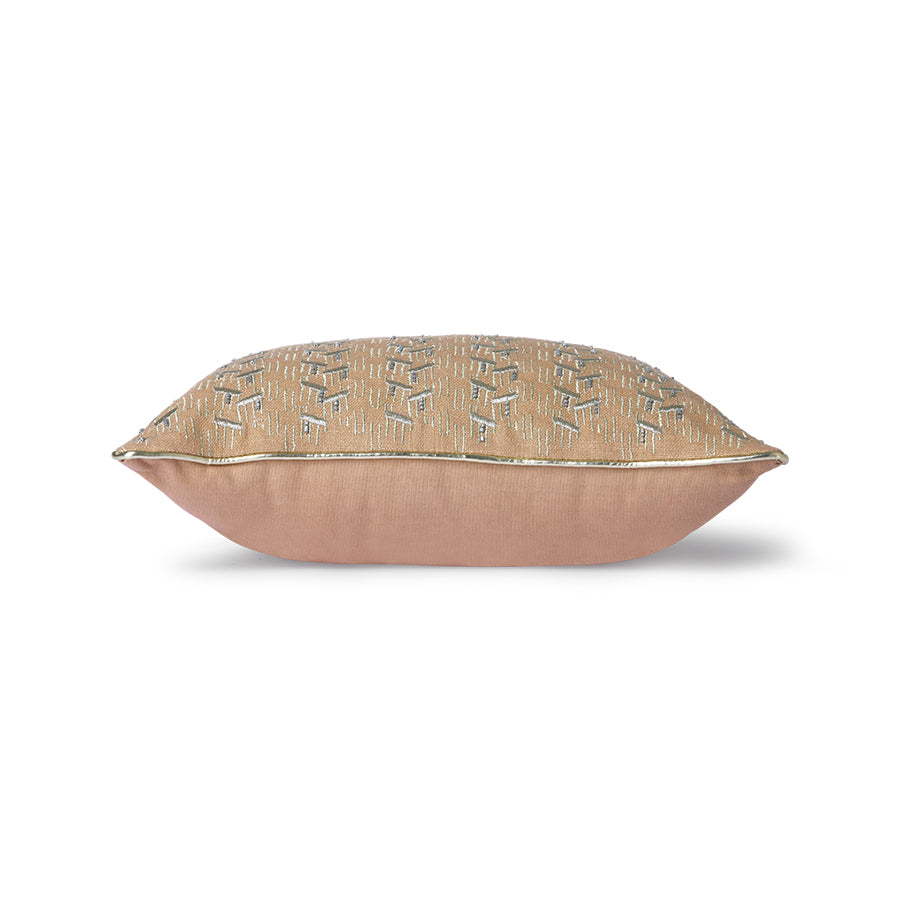 blush colored pillow with silver trim and glass beads sewed on