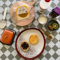 wooden spoon and kiwi in a bowl on a table with food