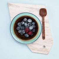 marble tray, ceramic plate and wooden spoon