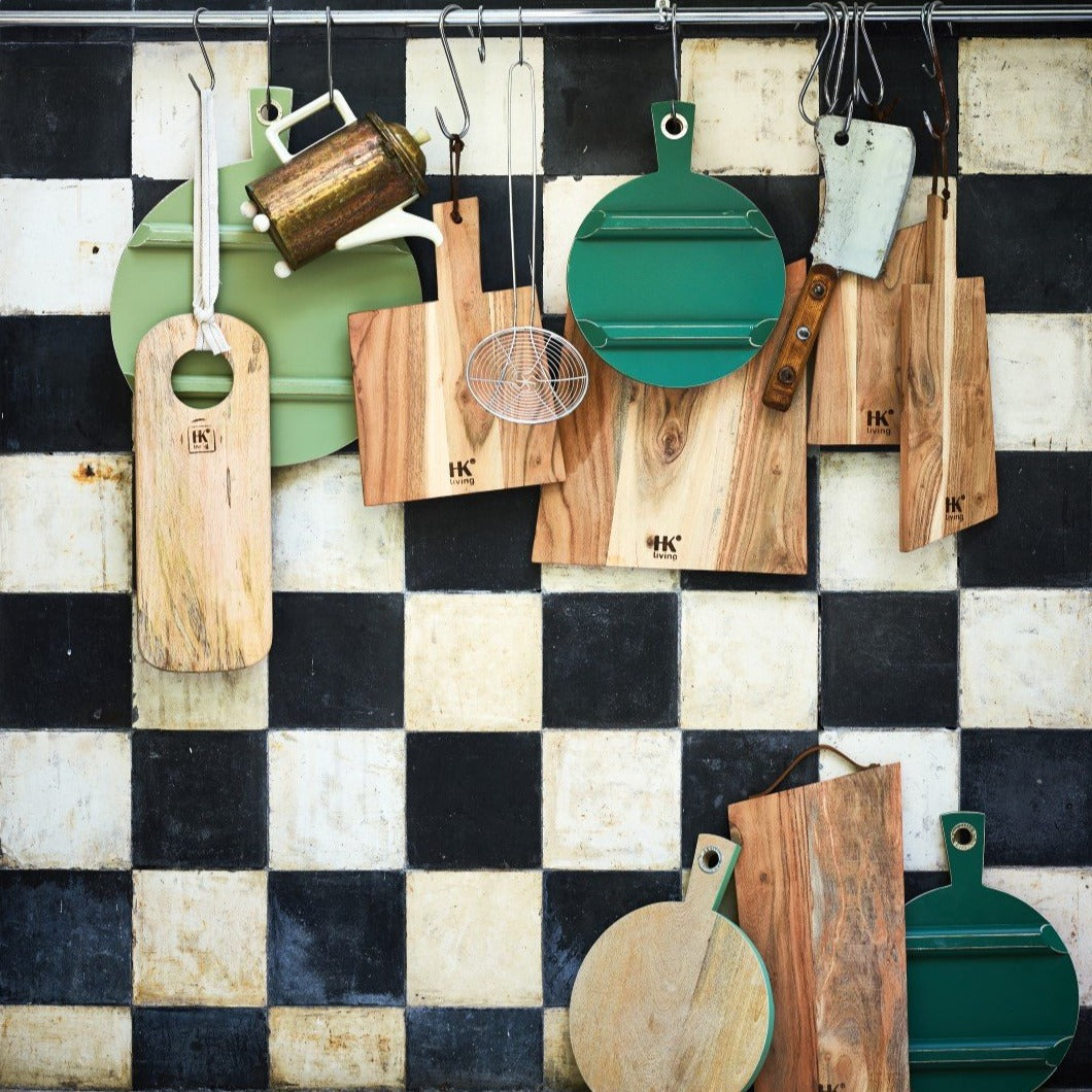 checkered back splash in black and white with wooden cutting boards on rack